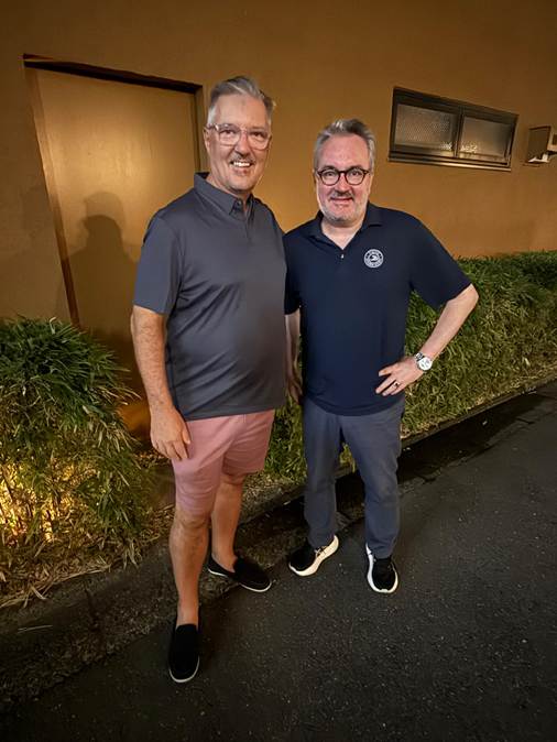 Two men standing next to each other

AI-generated content may be incorrect.