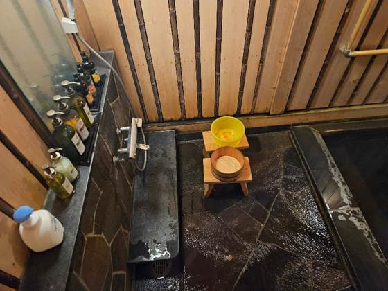 A bathroom with a sink and bottles

AI-generated content may be incorrect.