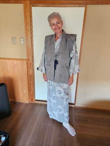 A person in a grey vest and white socks standing in a room

AI-generated content may be incorrect.