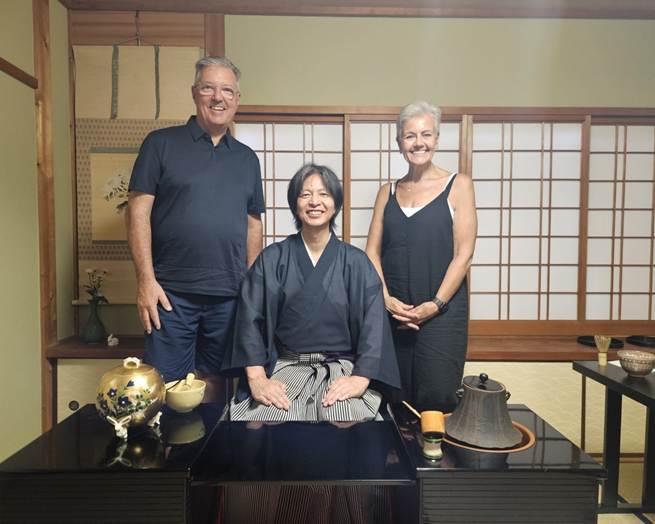 A group of people standing in front of a table

AI-generated content may be incorrect.