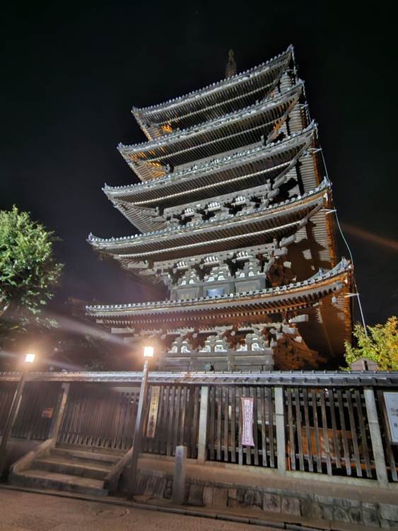 A tall building with a fence and trees

AI-generated content may be incorrect.