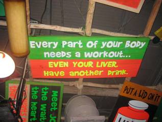 Wall sign at the bar reading 'Every part of your body needs a workout, even your liver, have another drink'