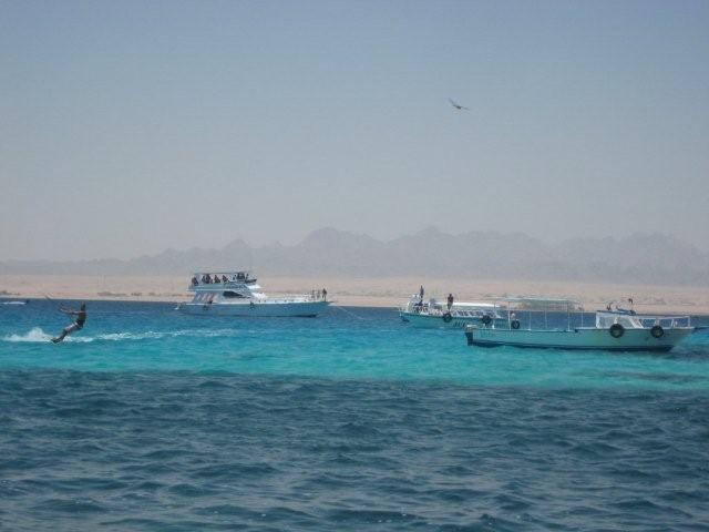 Boats on the Red Sea with desert mountains behind