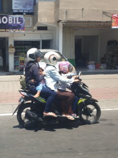 A family of four on a moped in Bali