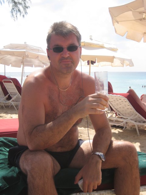Jeff relaxing on a sun lounger with a drink
