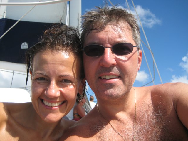 Jeff and Caroline sitting on the bow of the boat
