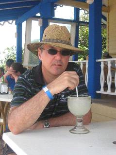 Enjoying a margarita in a straw hat and sunglasses