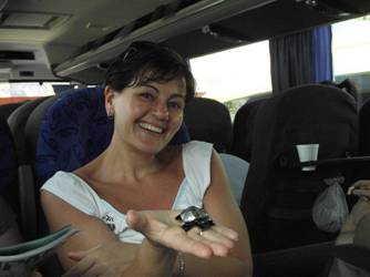 Caroline holding an obsidian tortoise on the coach