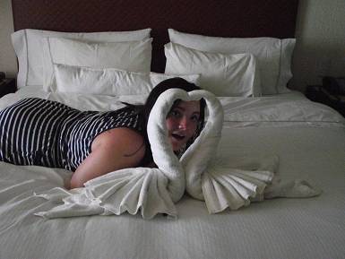 Sian with towel swans folded on the bed