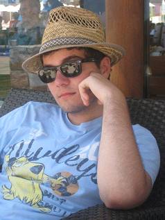 A man in a straw hat and sunglasses relaxing