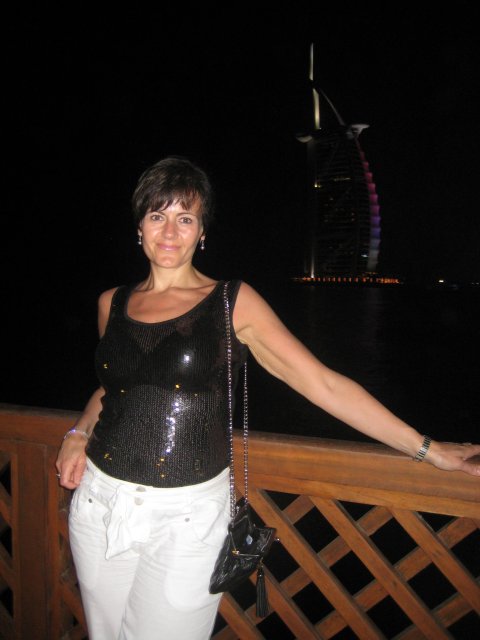 Mrs K at night with the Burj Al Arab lit up behind
