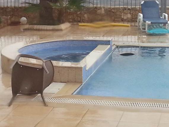 Chairs blown into the pool by the storm