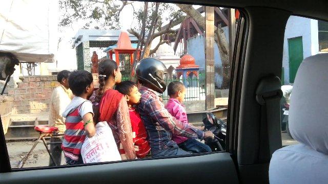 Five people riding on one motorbike
