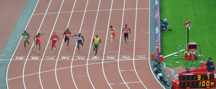 Sprinters crossing the finish line in the 100m final