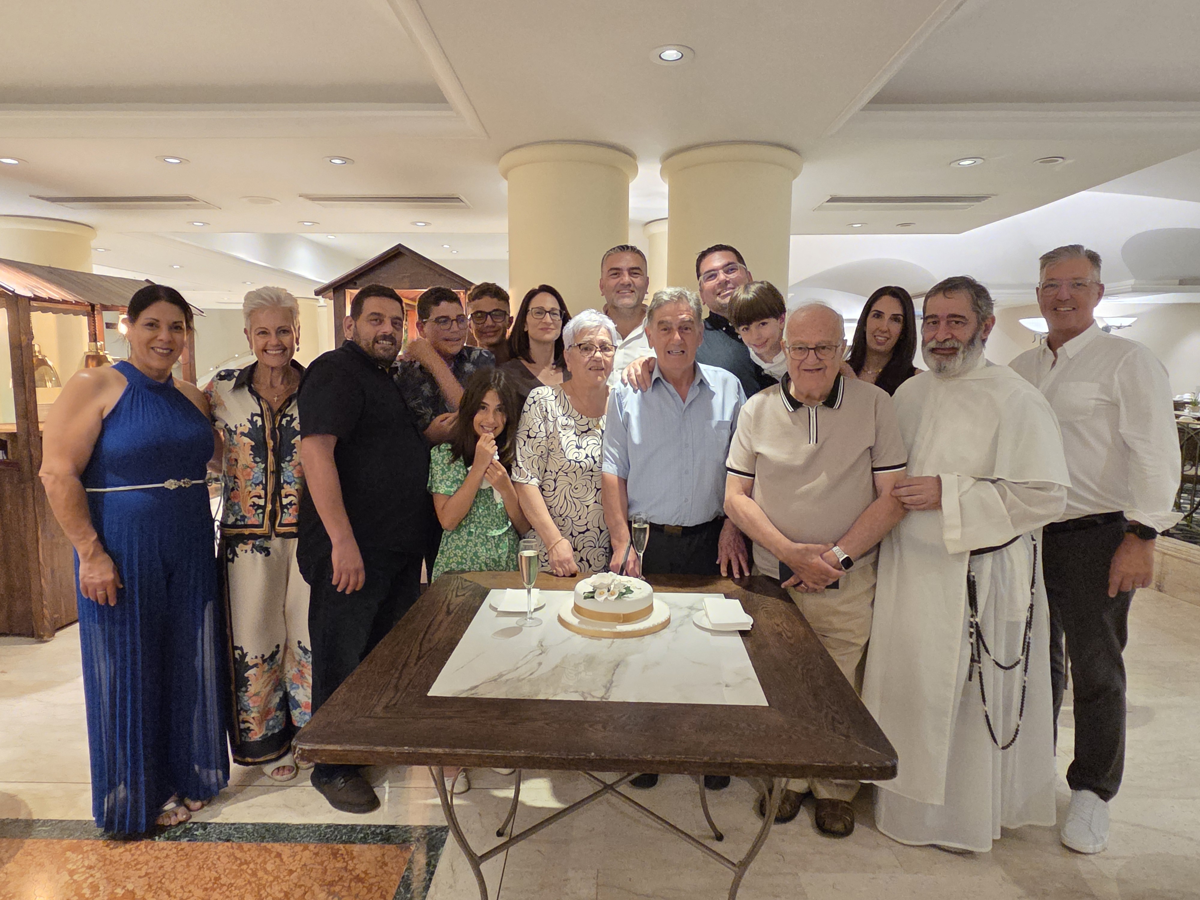 Family gathered around a cake