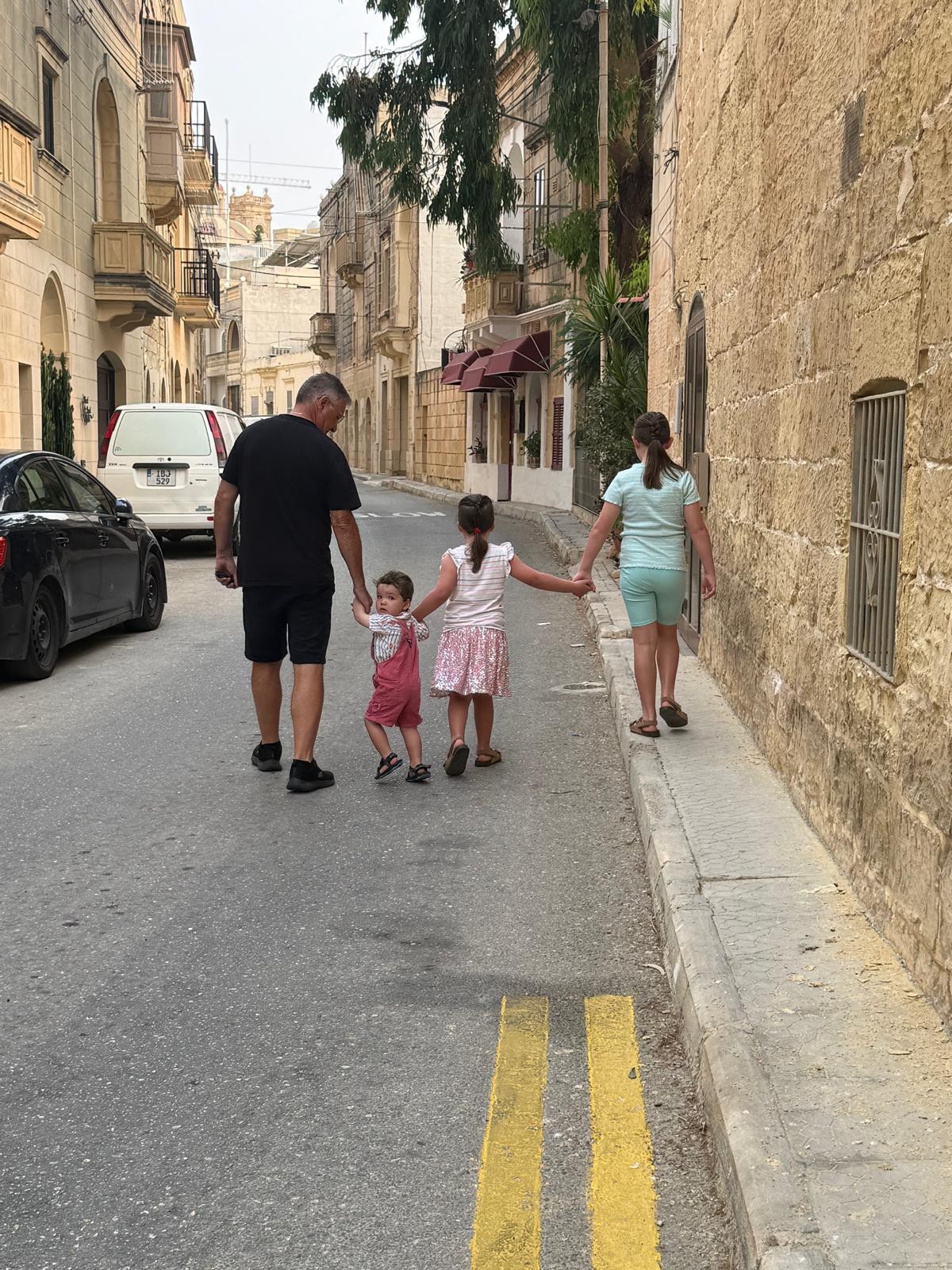 Jeff walking with grandkids in Gharb