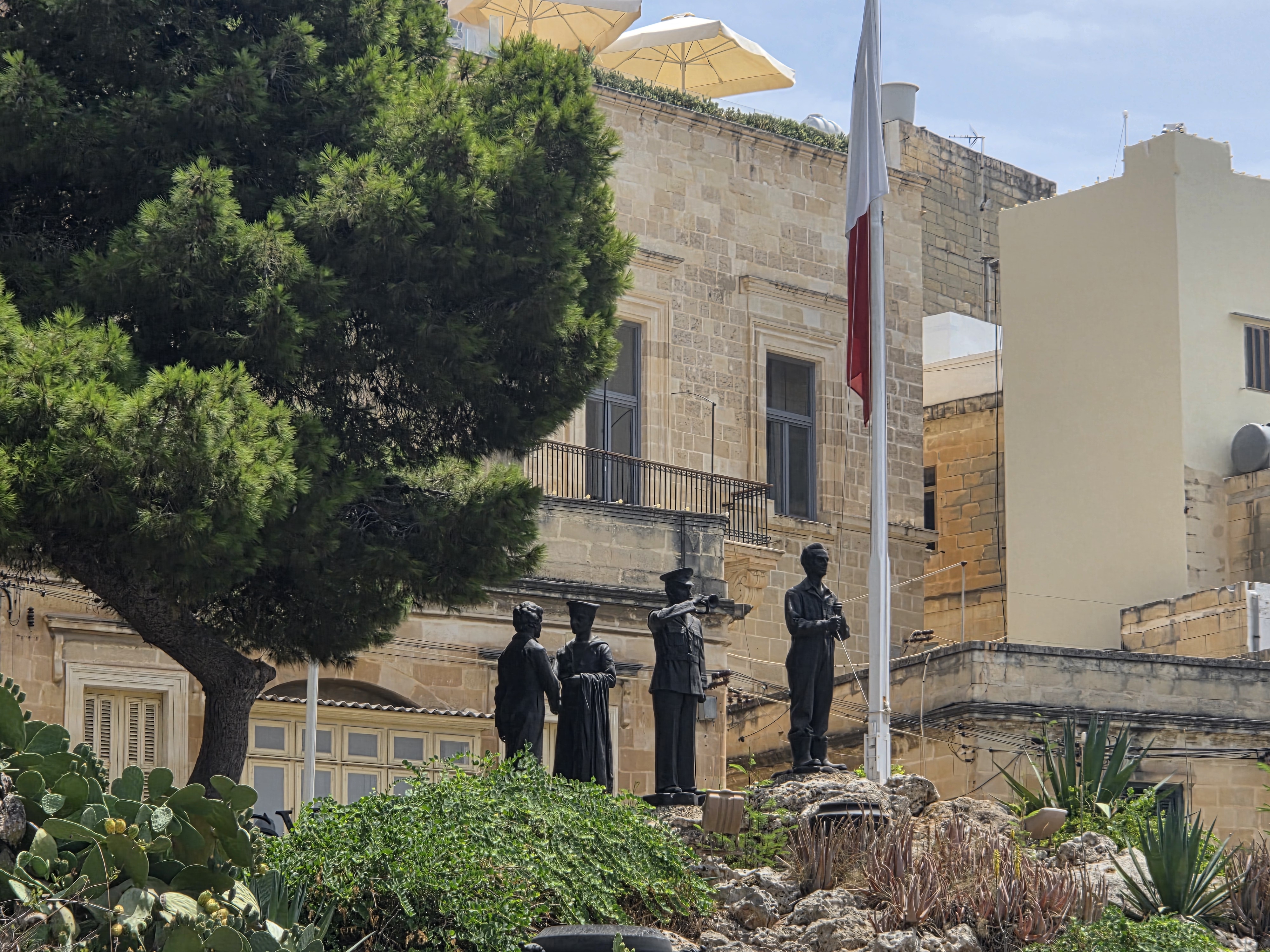 Historical building with flag and statues