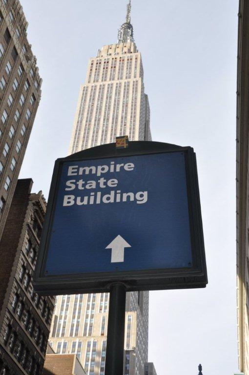 A street sign pointing to the Empire State Building