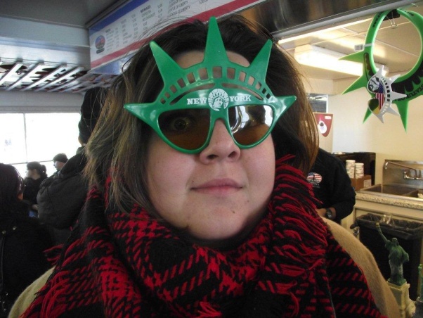 Holly wearing novelty Statue of Liberty sunglasses